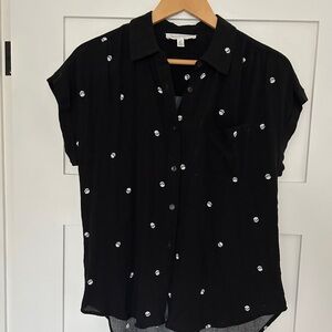 Black button up blouse with rolled sleeves and skull motif